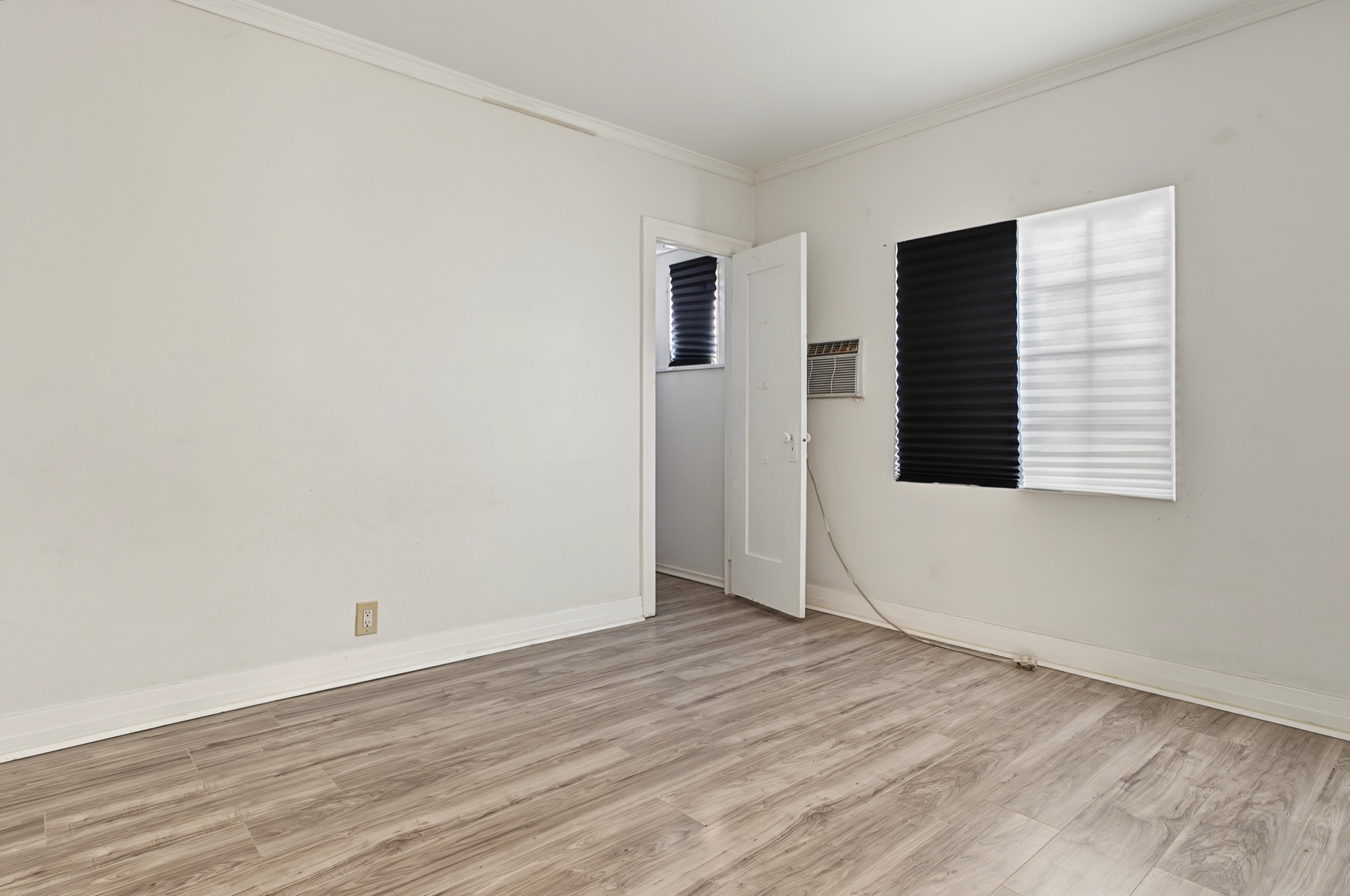 Unfurnished bedroom with wood-look flooring and a window at 2829 S Rimpau