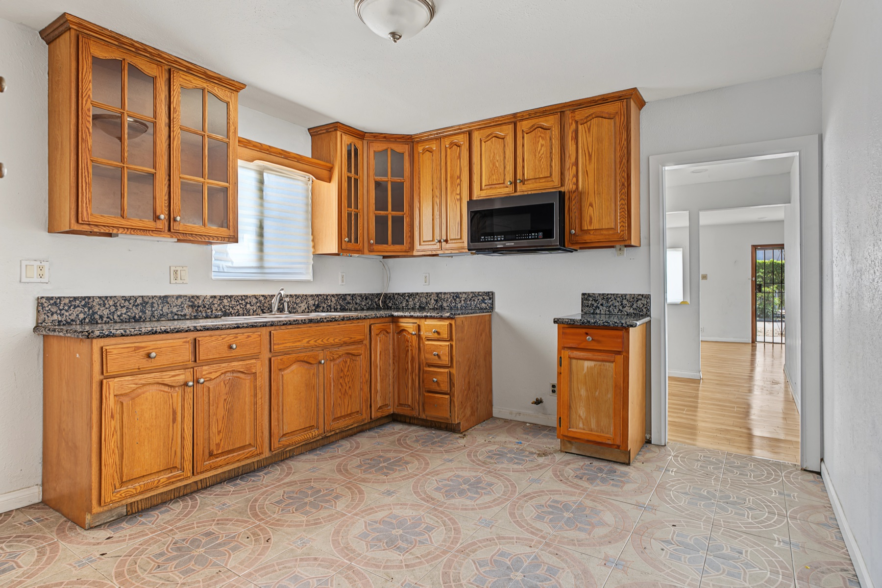 Kitchen with wood cabinetry and granite counters at 2829 S Rimpau